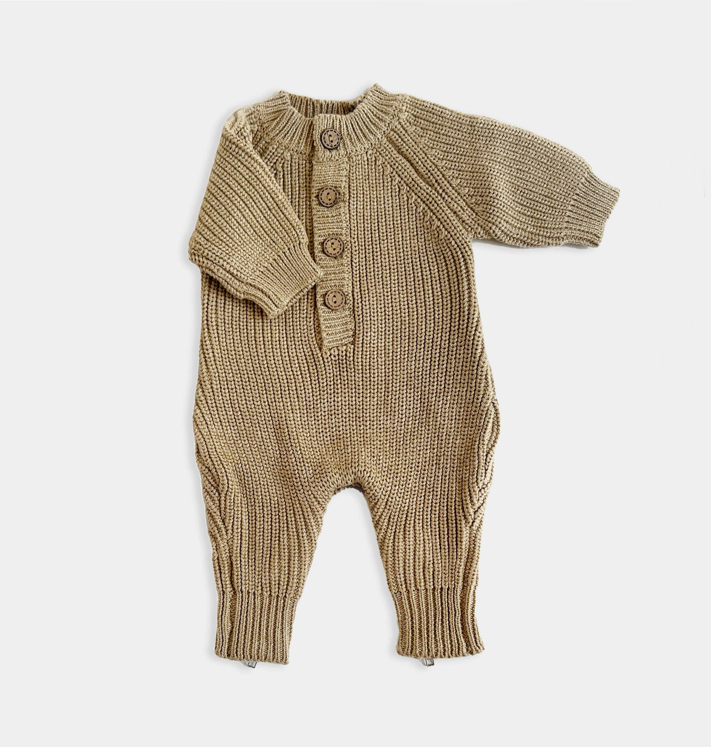 Knitted baby romper with buttons on a white background