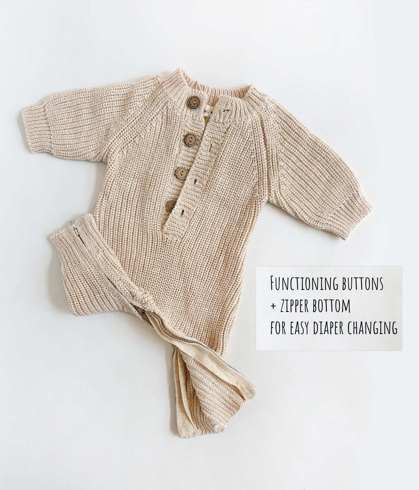 Beige baby cardigan with buttons and zipper on a white background