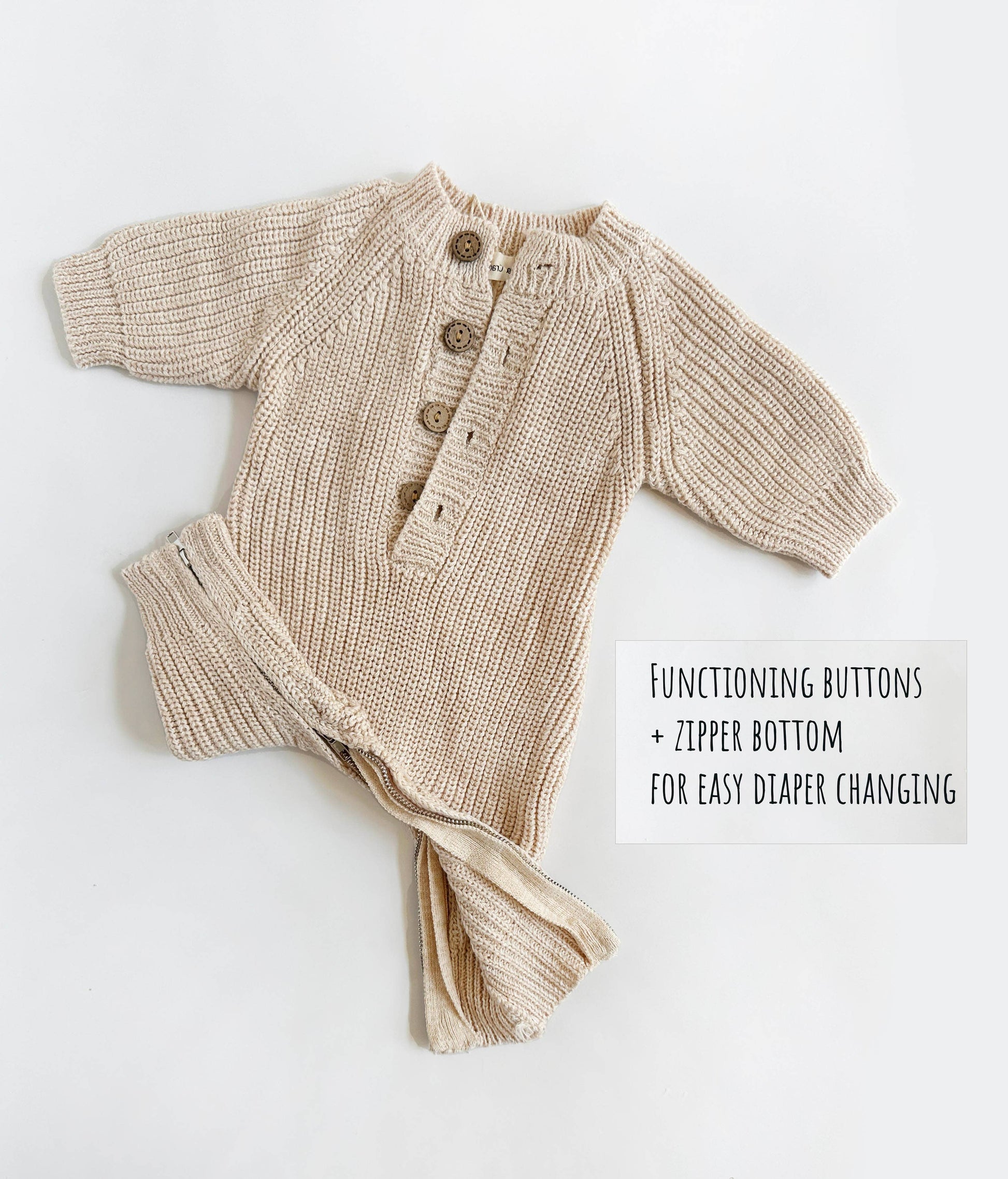 Beige baby cardigan with buttons and zipper on a white background