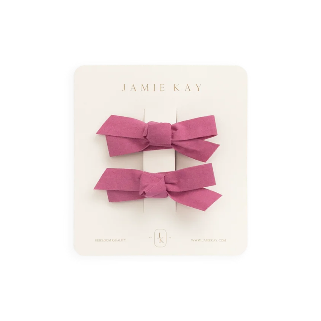 Two pink satin ribbon hair bows on a white Jamie Kay display card, photographed against a solid white background.