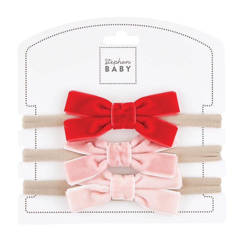 Set of two velvet hair bows, one red and one pink, on a white background with 'Stephan Baby' branding.