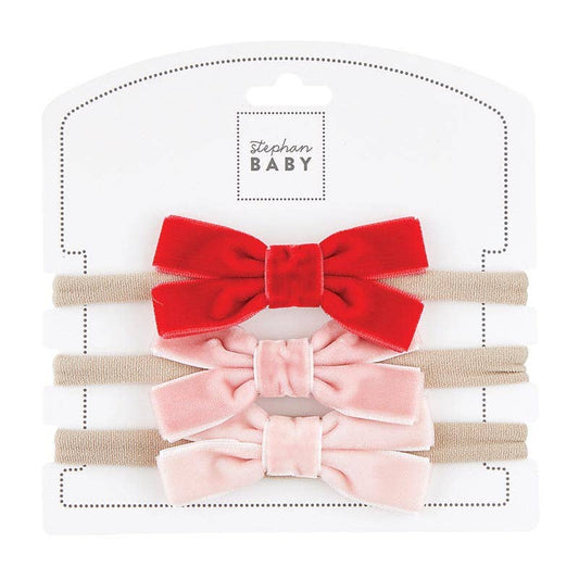 Set of two velvet hair bows, one red and one pink, on a white background with 'Stephan Baby' branding.