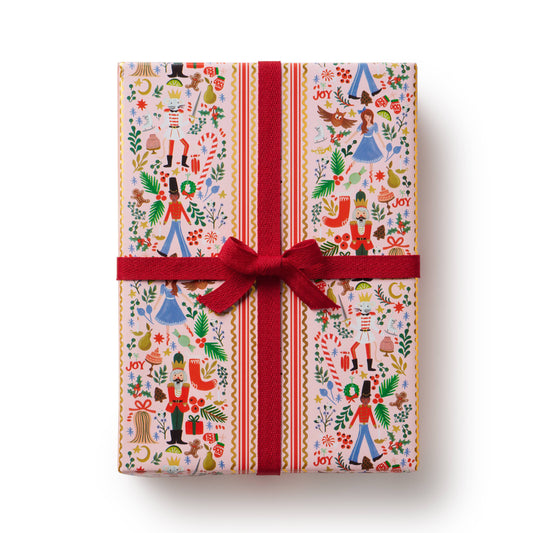 Gift box with festive design and red ribbon on a white background