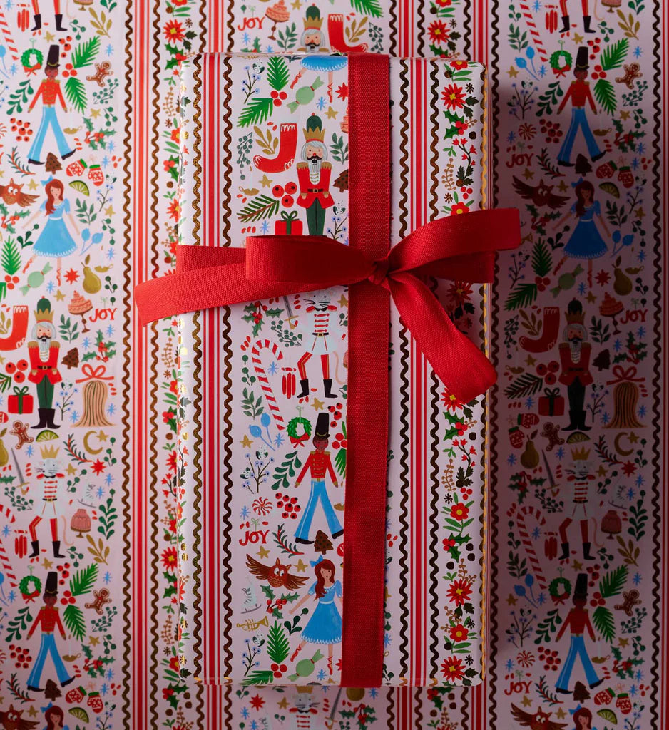 Gift wrapped in festive paper with a red ribbon
