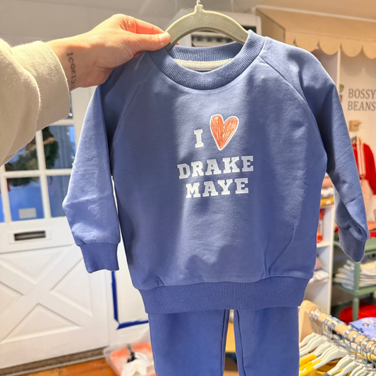 Blue children's sweatshirt with 'I ❤️ Drake Maye' text on a hanger.