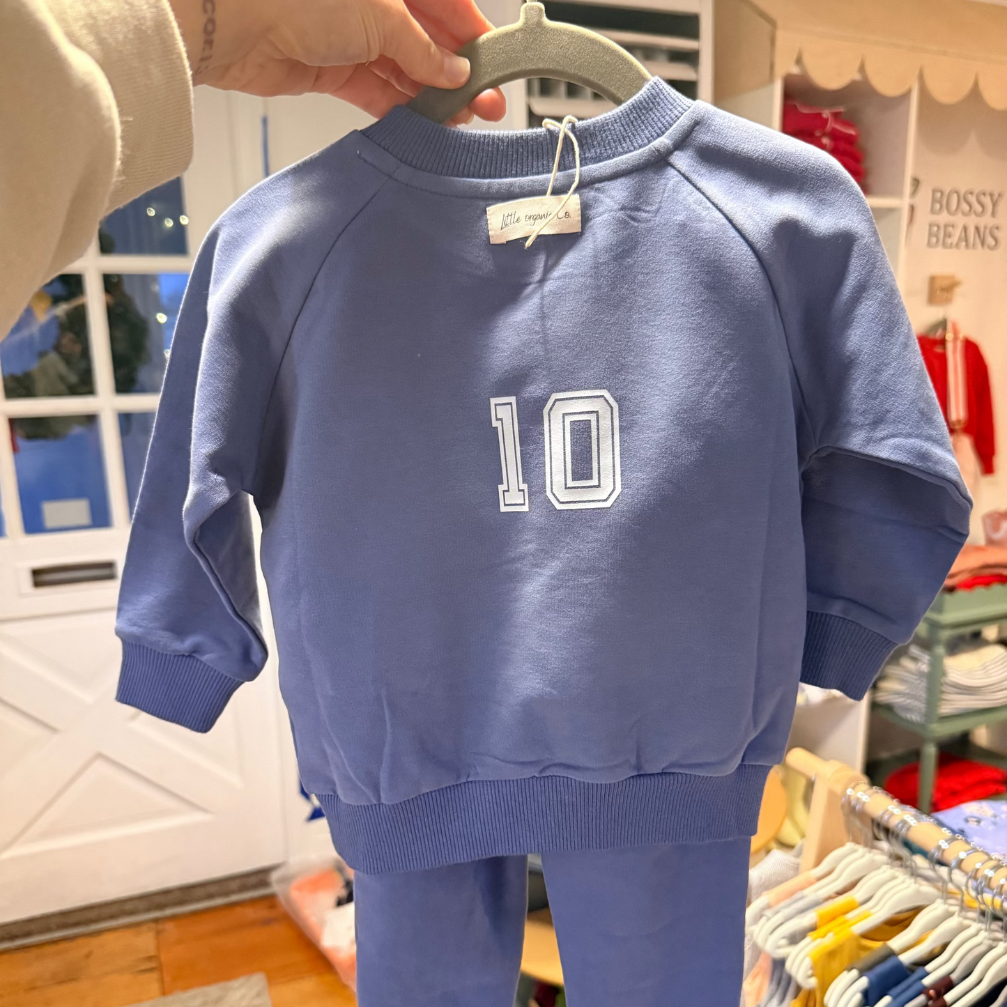 I love Drake Maye Sweatsuit outfit with number 10 on a hanger in a store setting