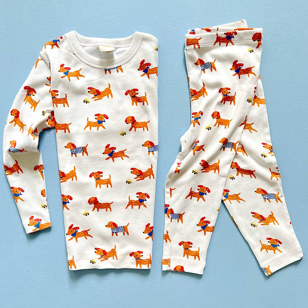 Children's pajama set with dog pattern on a blue background