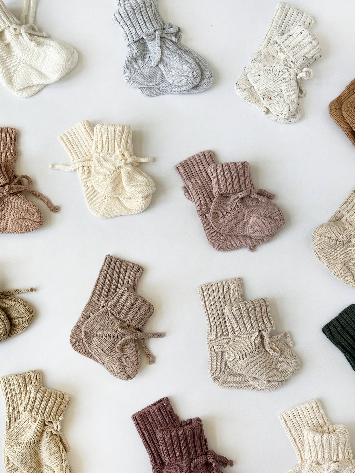 Collection of baby socks in various colors on a white background