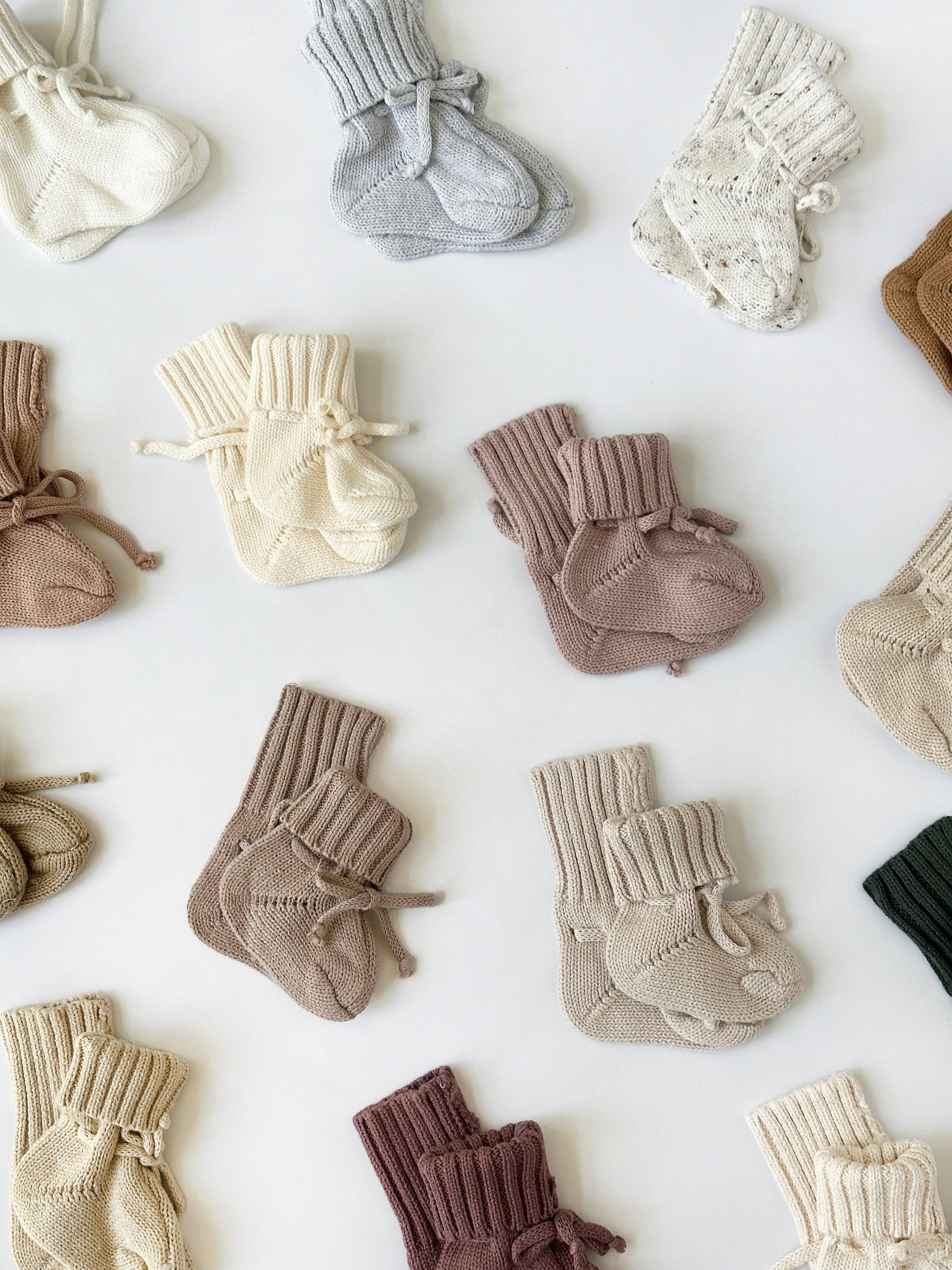 Collection of baby socks in various colors on a white background