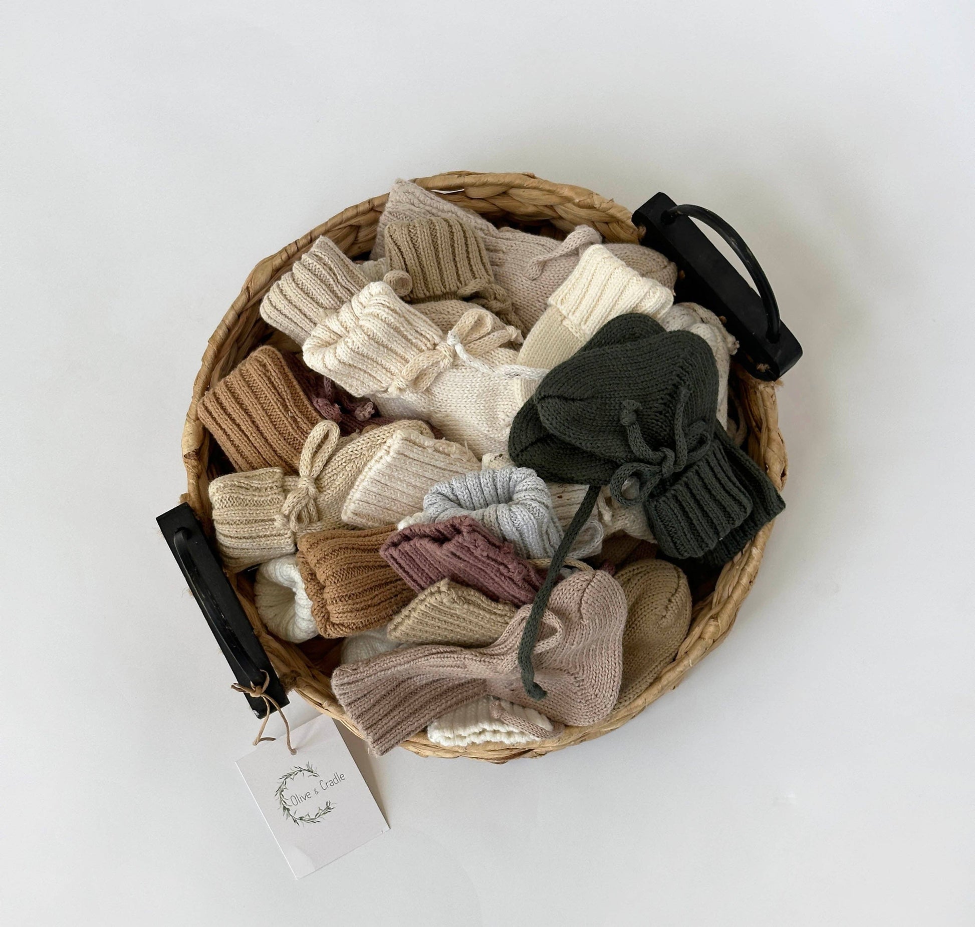 Basket of knit bow hair clips on a white background