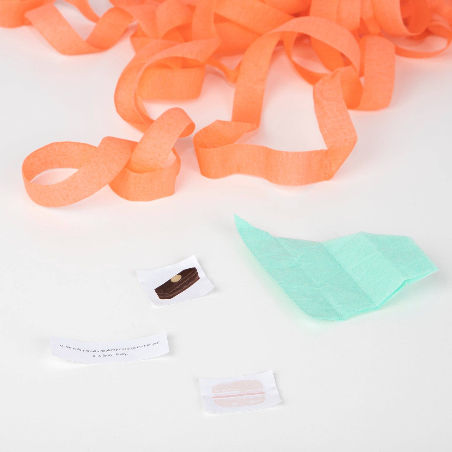 Orange ribbons and small items on a white background