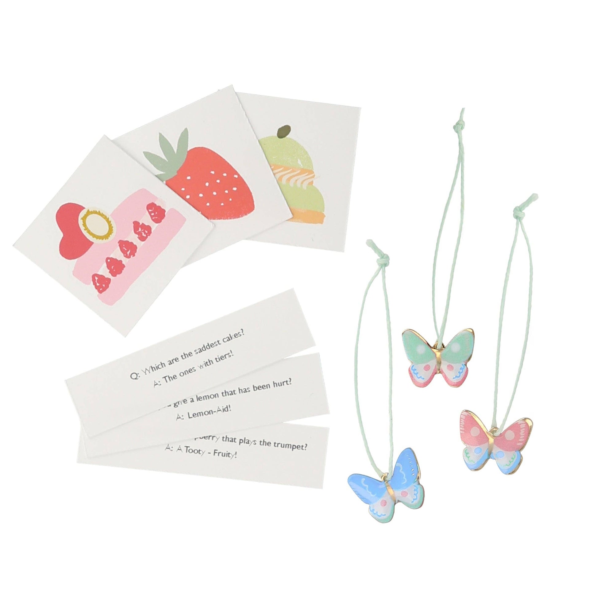 Butterfly necklaces with cards featuring fruit illustrations on a white background