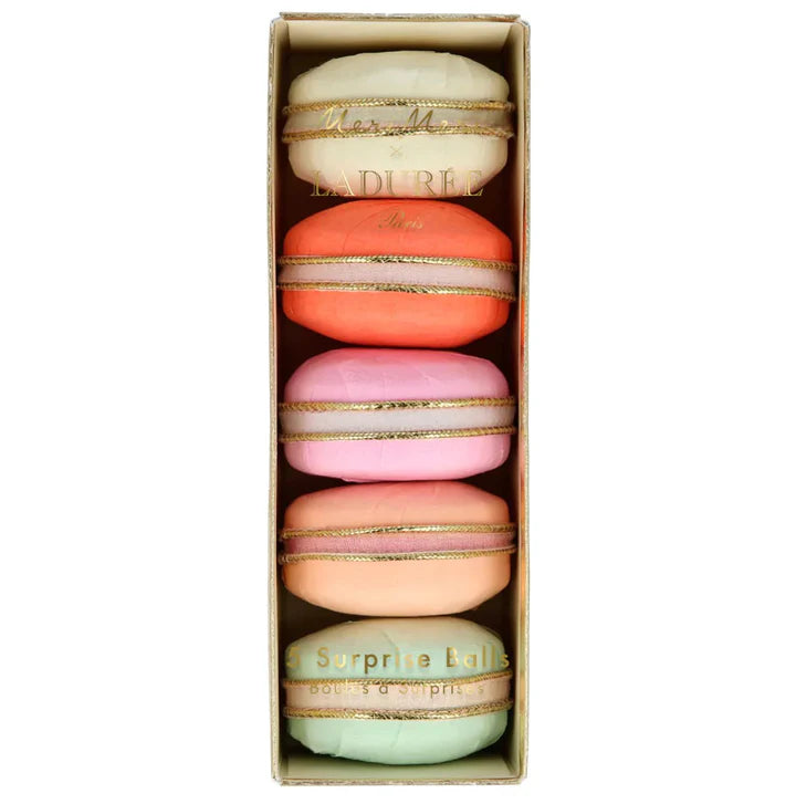 Box of colorful macarons with Ladurèe branding on a white background