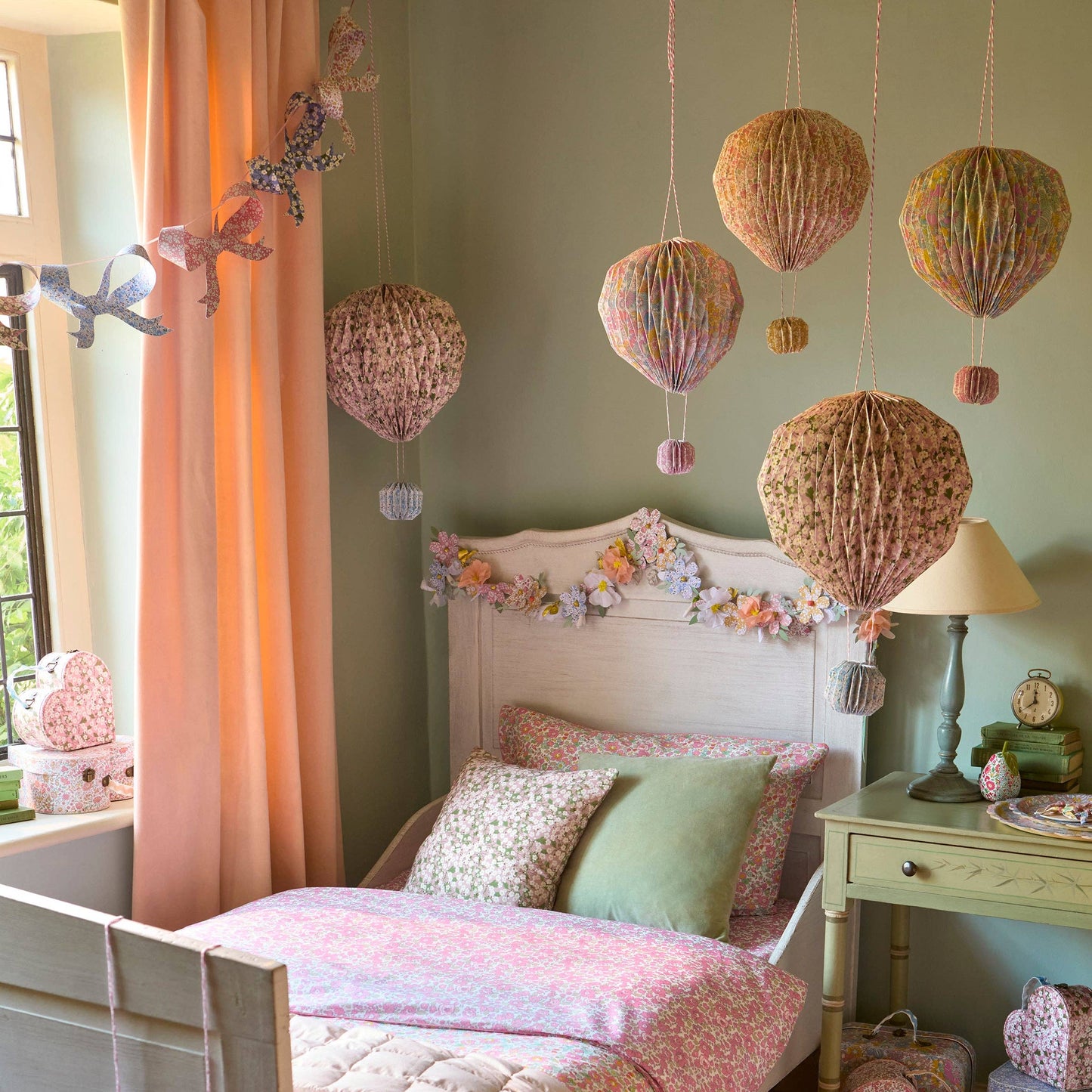 Children's bedroom with decorative hot air balloons and floral headboard