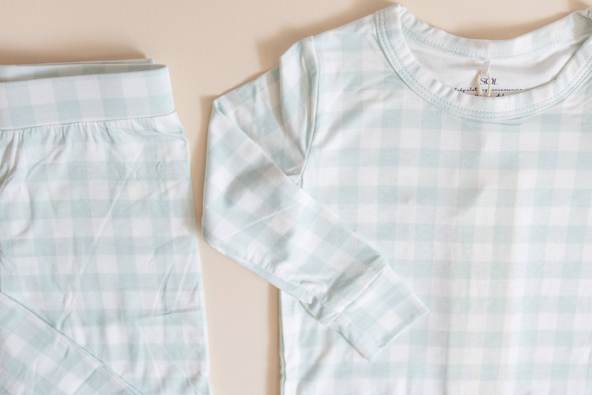 Light blue checkered shirt and shorts on a beige background