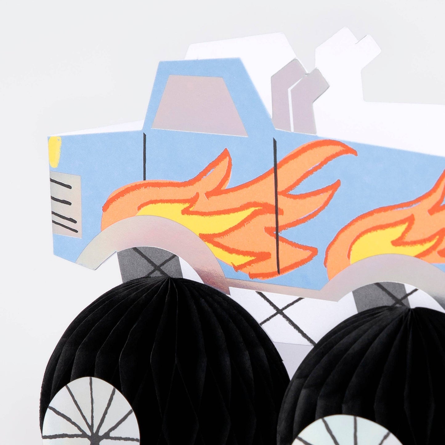 Cardboard cutout of a truck with flames on a white background