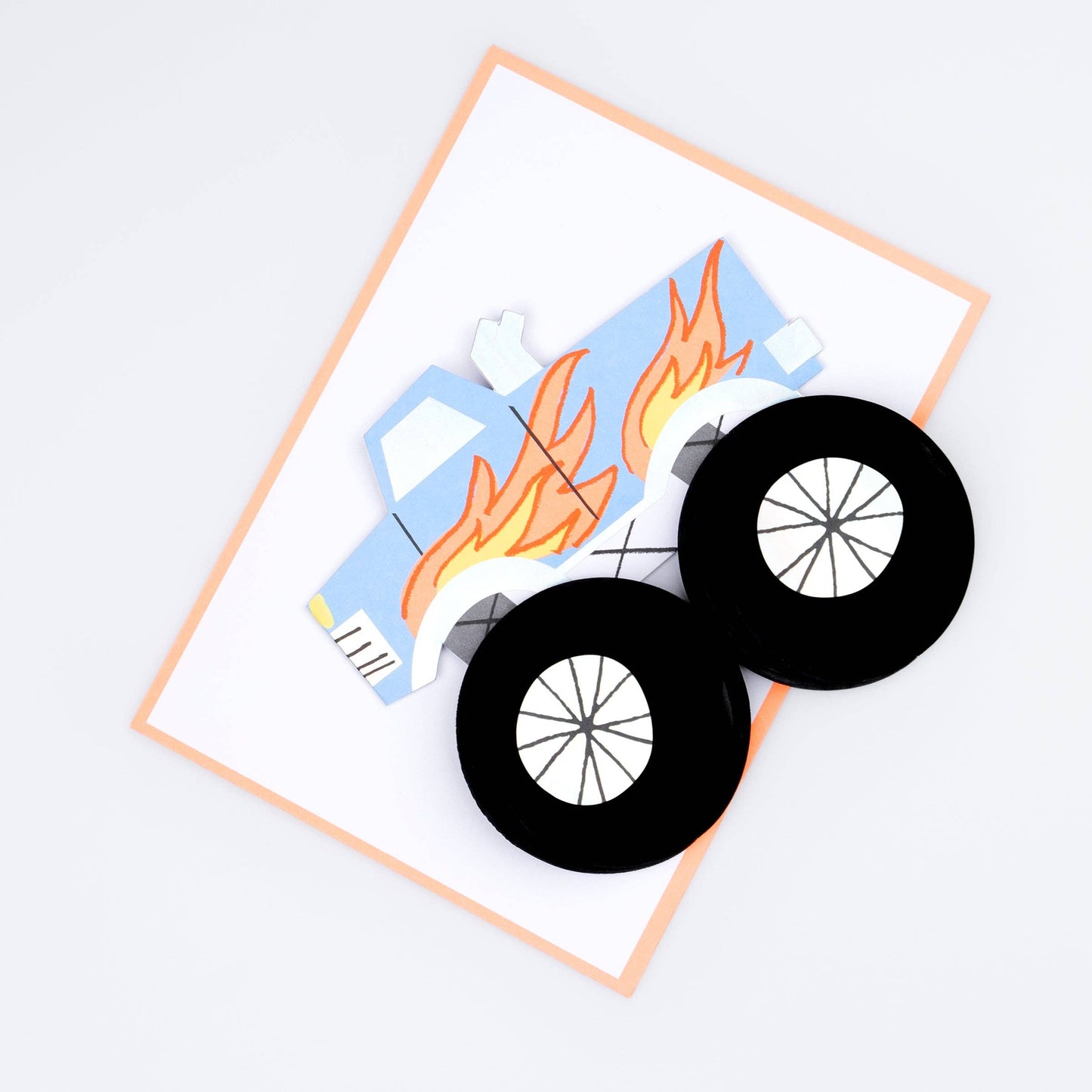 Toy truck with flames and black wheels on a white background