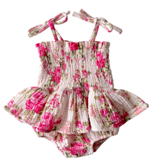 Floral baby romper with matching headband on a white background