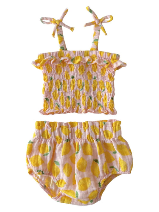 Two-piece baby outfit with lemon pattern on a white background