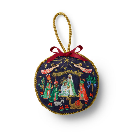 Embroidered Christmas ornament with nativity scene design on a white background