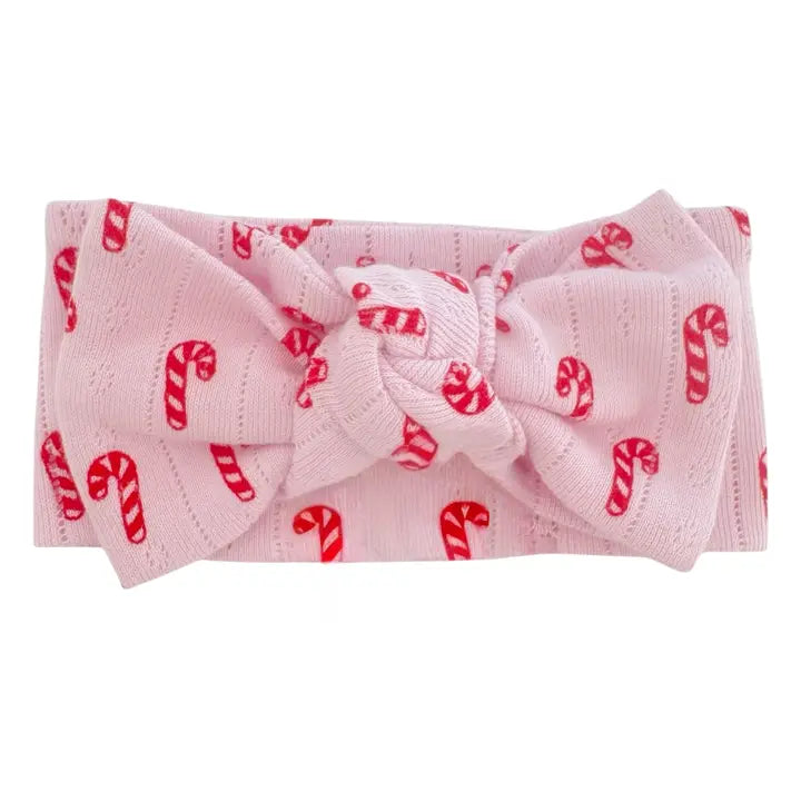 Pink headband with candy cane pattern on a white background