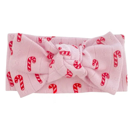 Pink headband with candy cane pattern on a white background