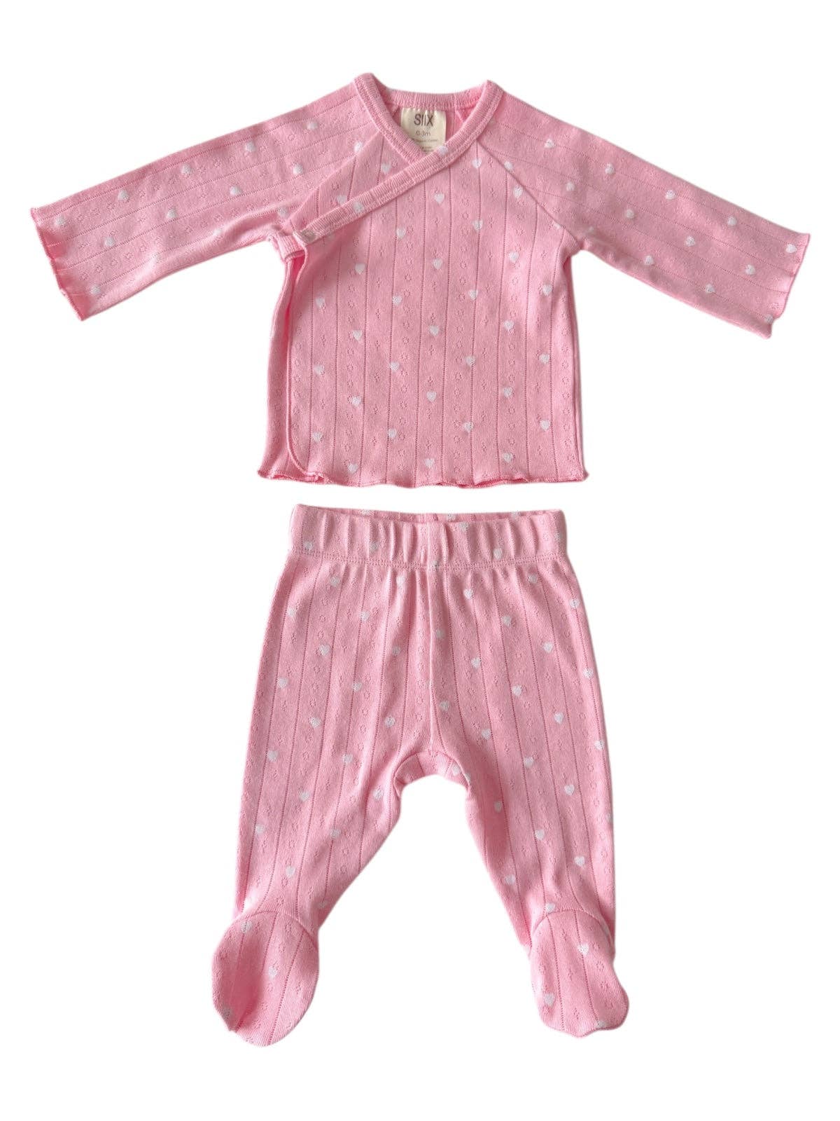 Pink baby outfit with long-sleeve top and footed pants on a white background