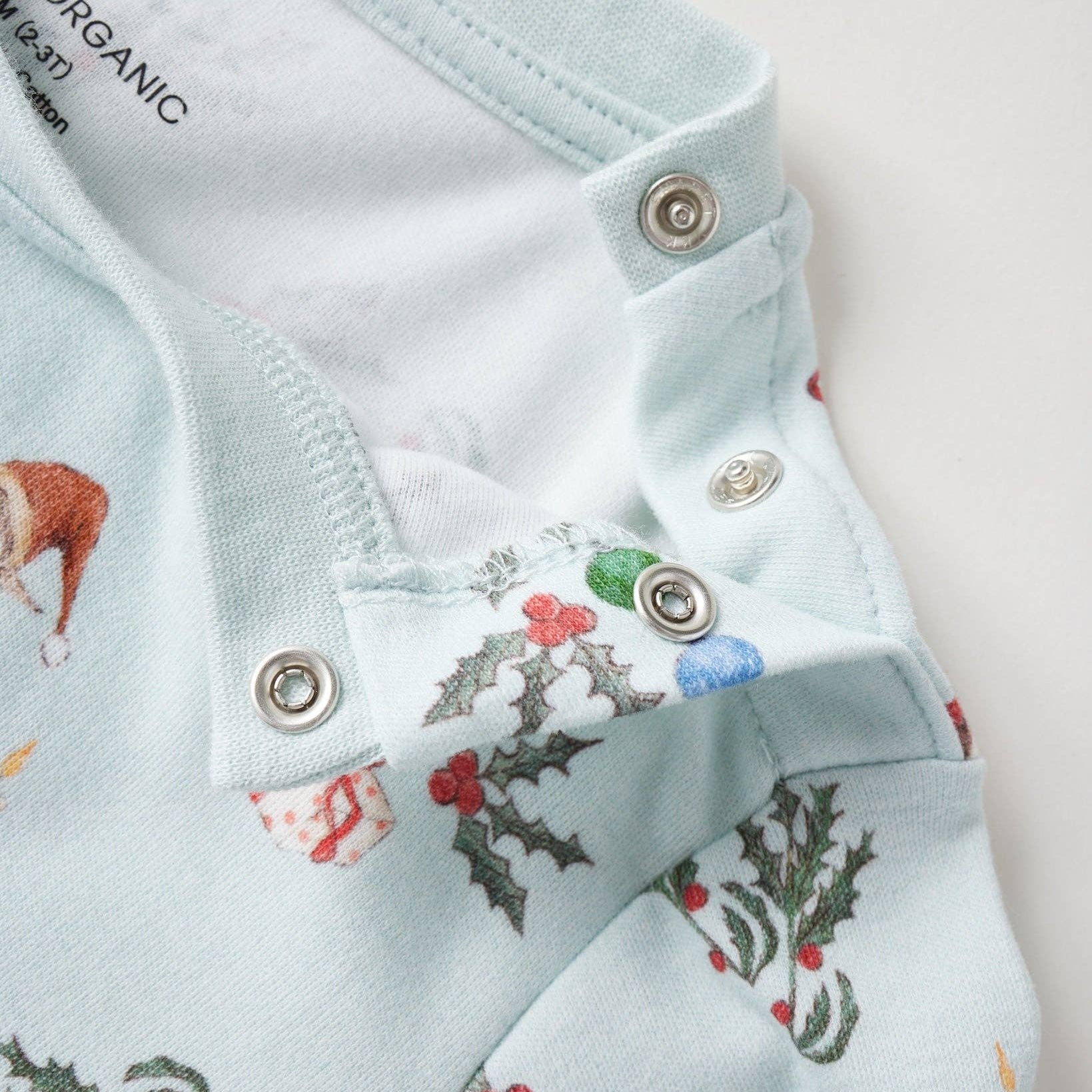 Children's shirt with Christmas-themed design on a light blue background