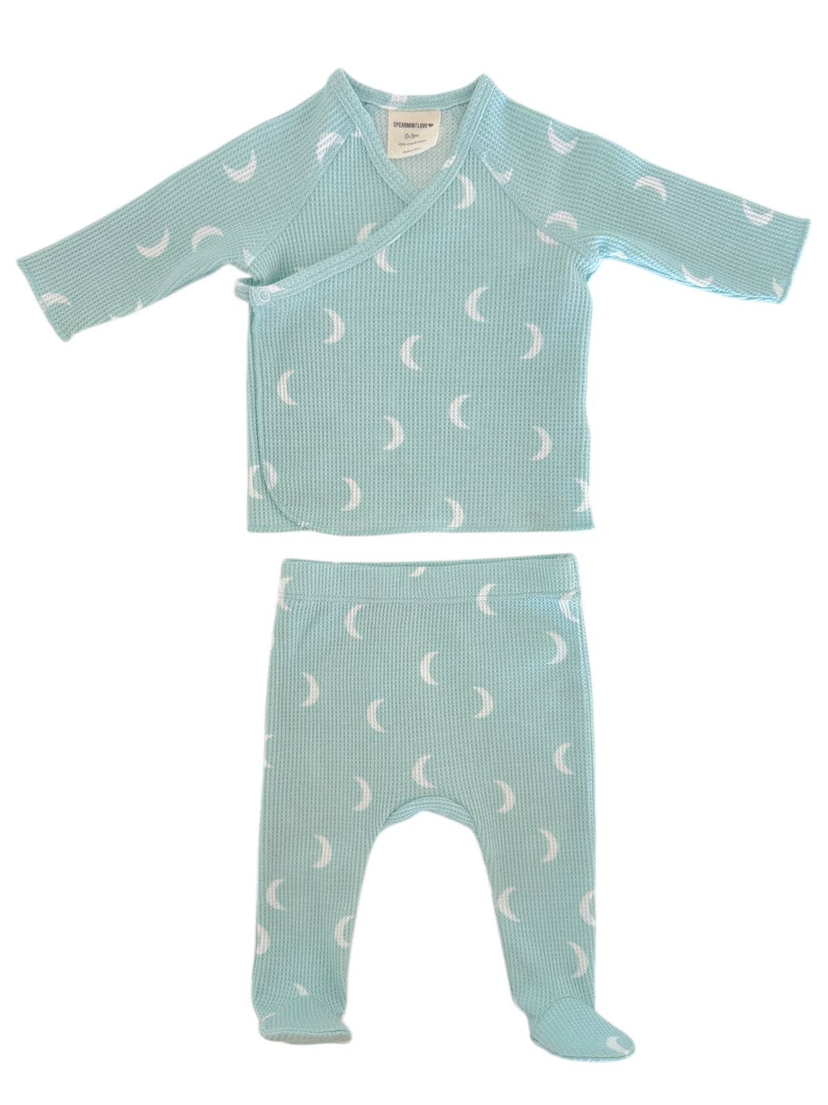 Baby outfit set with top and pants featuring moon pattern on a white background