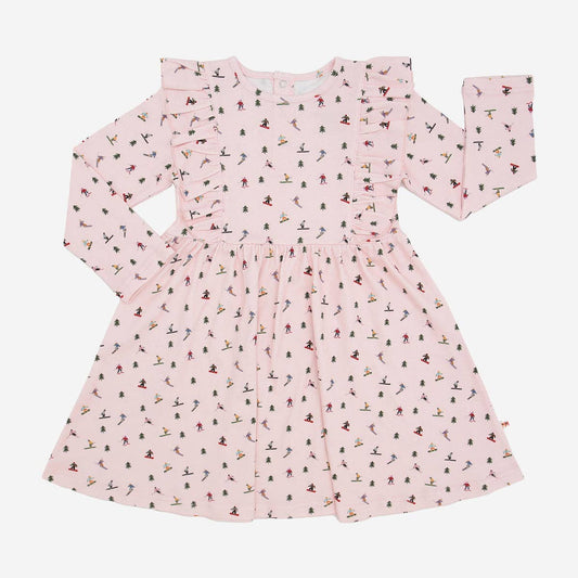 A long-sleeve baby dress in light pink with an all-over small multicolor print, laid flat against a light gray background.