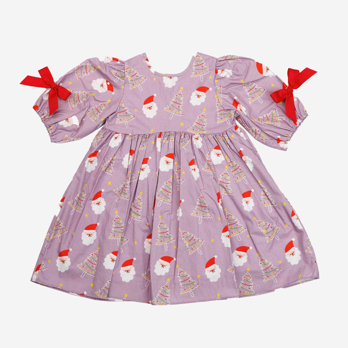 A baby girl's long-sleeve dress in dusty lavender purple, featuring an all-over print of Santa Claus faces and Christmas trees, with red ribbon bows on the sleeves, shown against a plain light gray background.