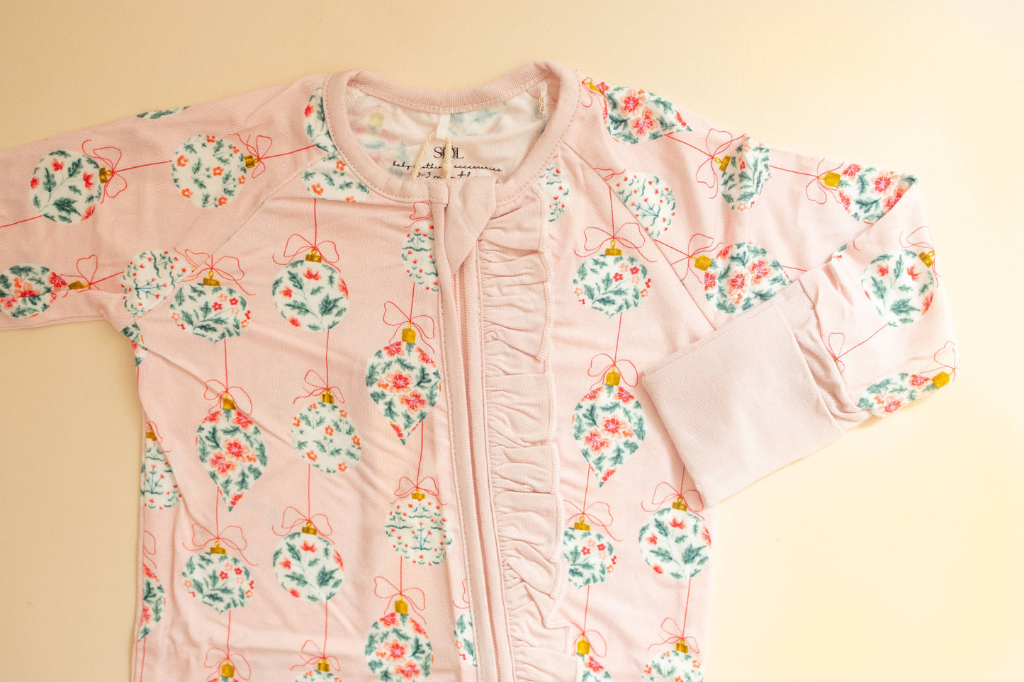 Pink floral-patterned jacket on a beige background