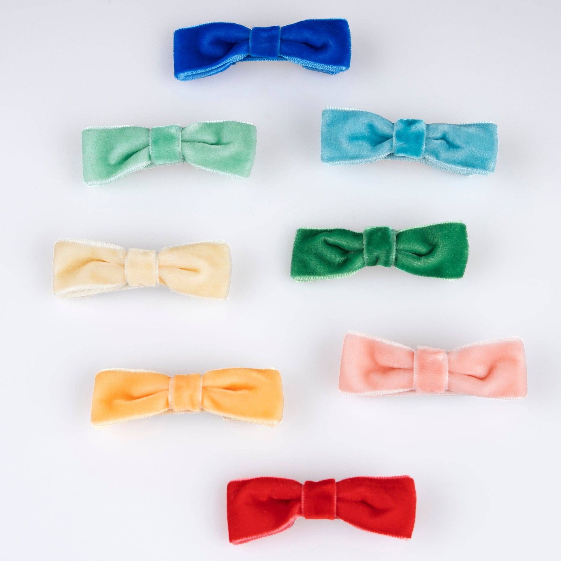Set of colorful bow-shaped hair accessories on a white background