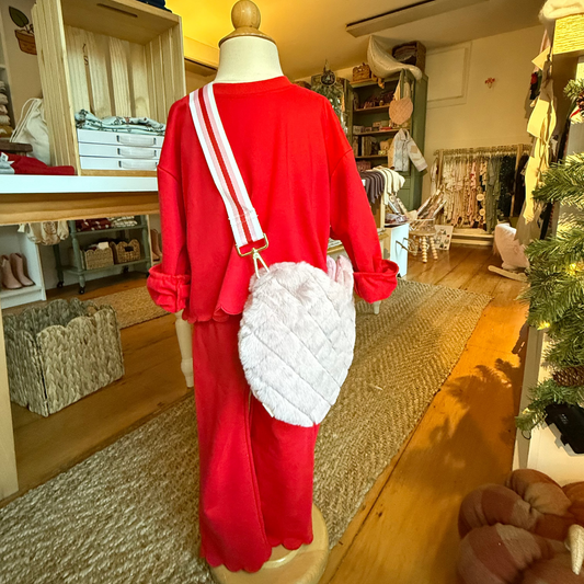 Image of red scalloped set on child mannequin with cross-body fuzzy meri meri heart purse