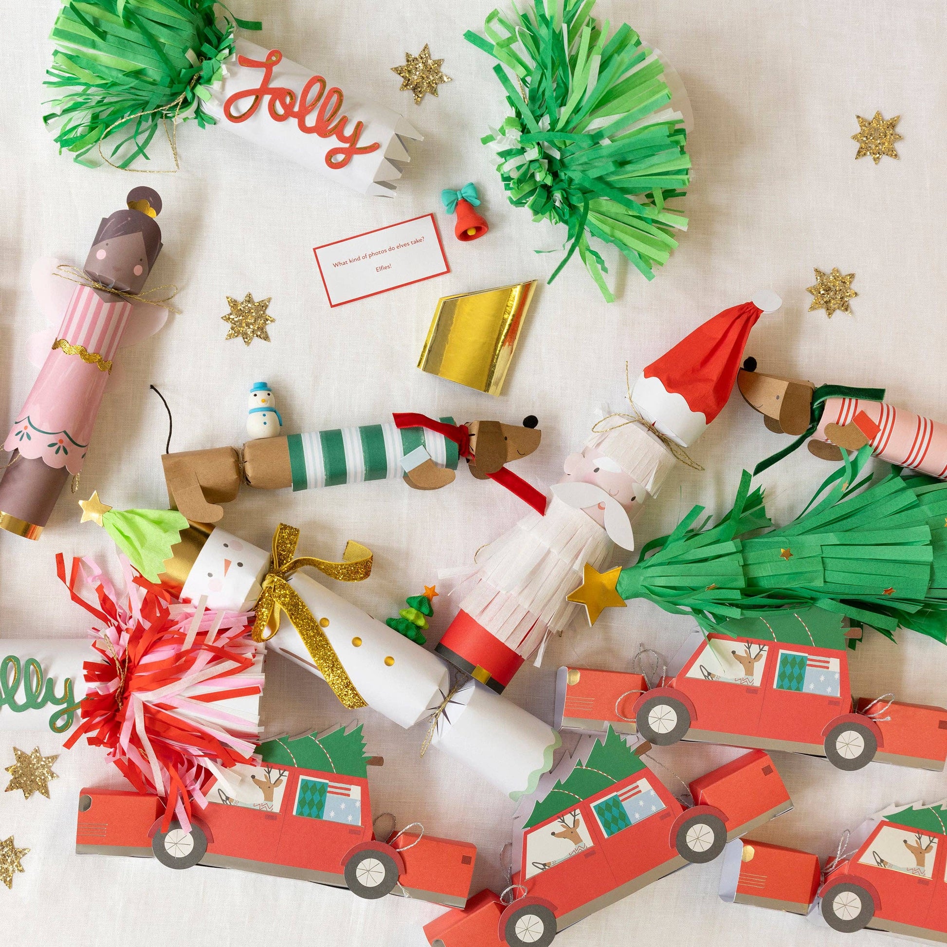 Collection of Christmas-themed paper crafts including trees, cars, and Santa Claus on a white background.