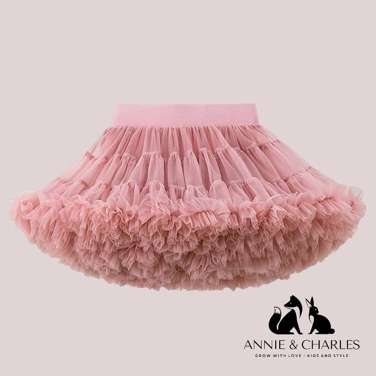 Pink tutu skirt on a light gray background with 'Annie & Charles' branding on graphic.