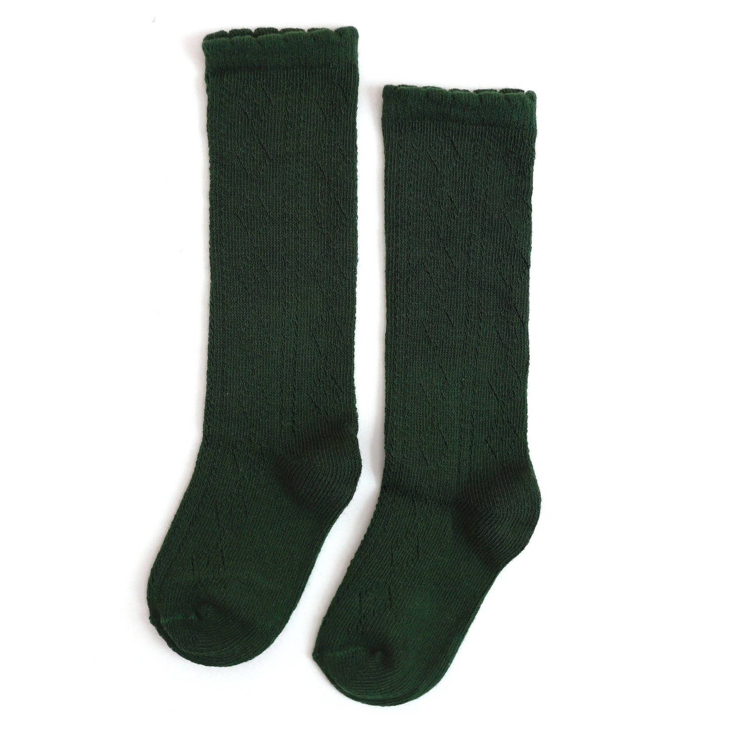 Pair of green knee-high socks on a white background