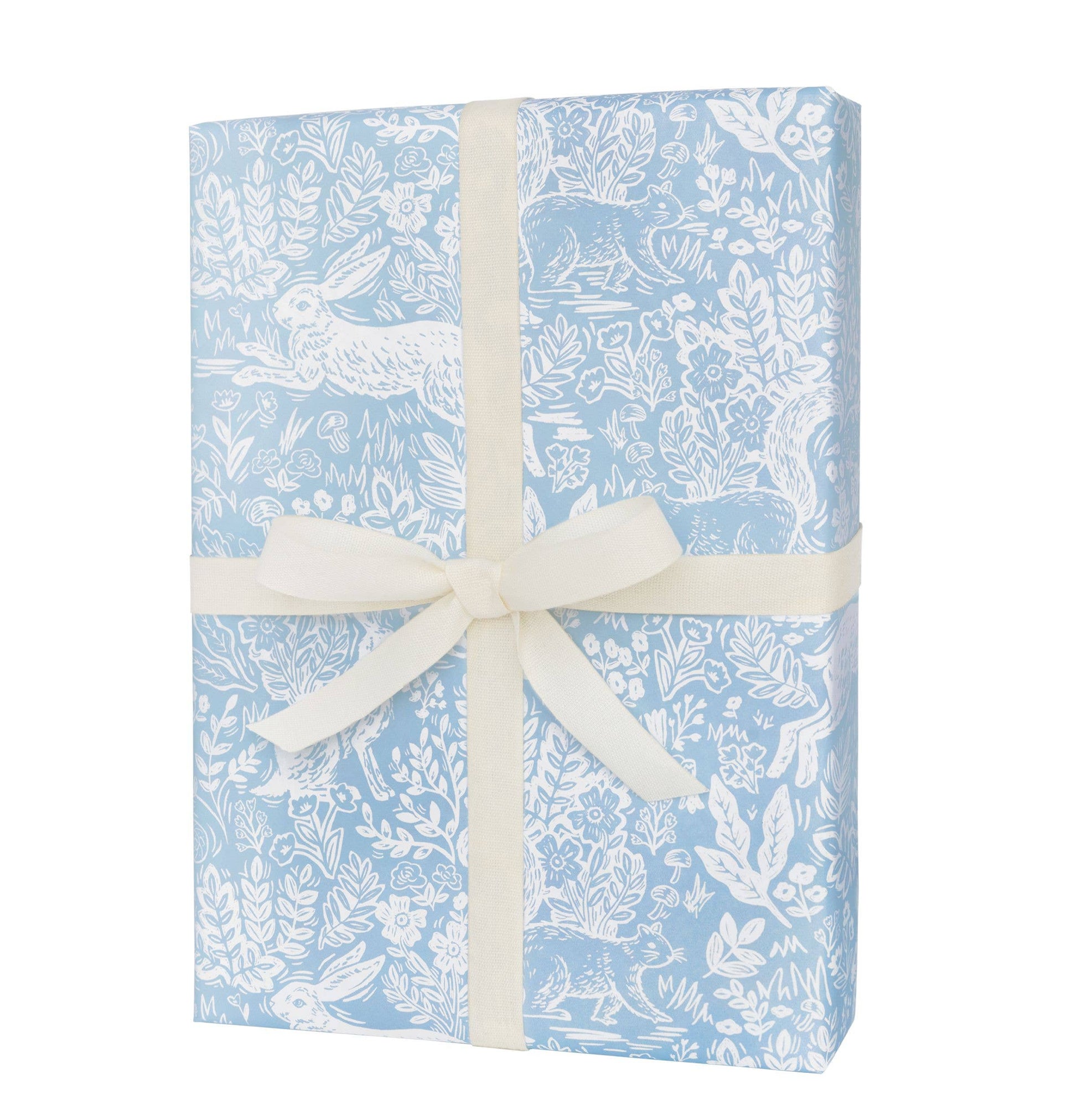 Gift box with blue floral pattern and white ribbon on a white background