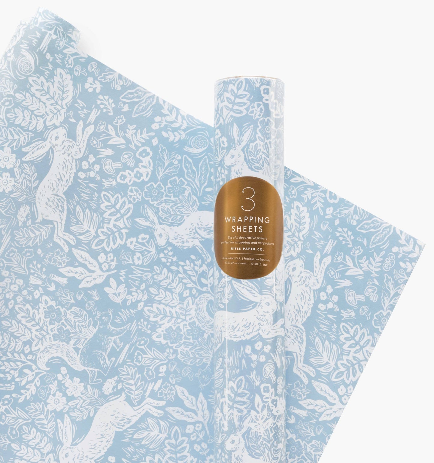 Roll of blue wrapping paper with white animal designs and a bottle of water on a white background