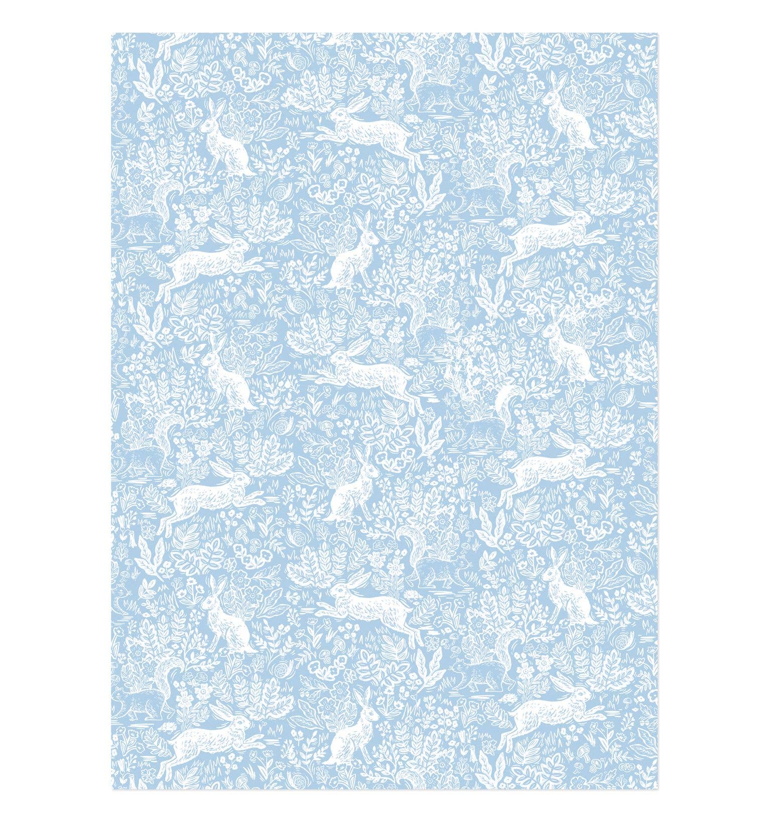 Patterned paper with white rabbit design on a light blue background
