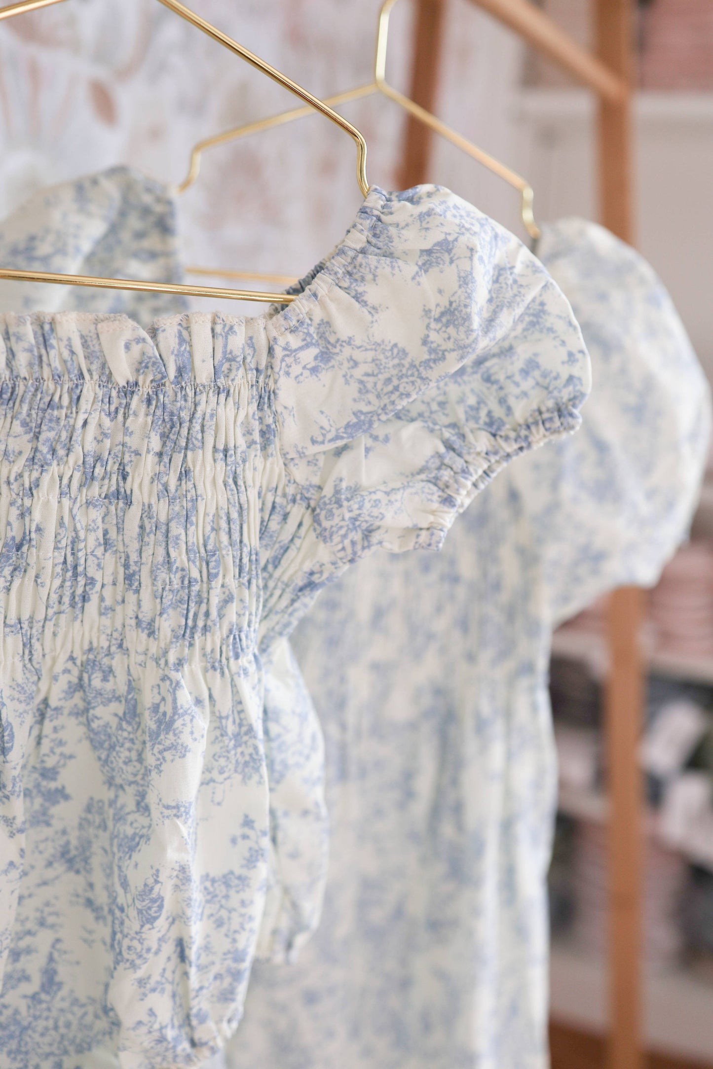 Floral dress on a hanger with a blurred background