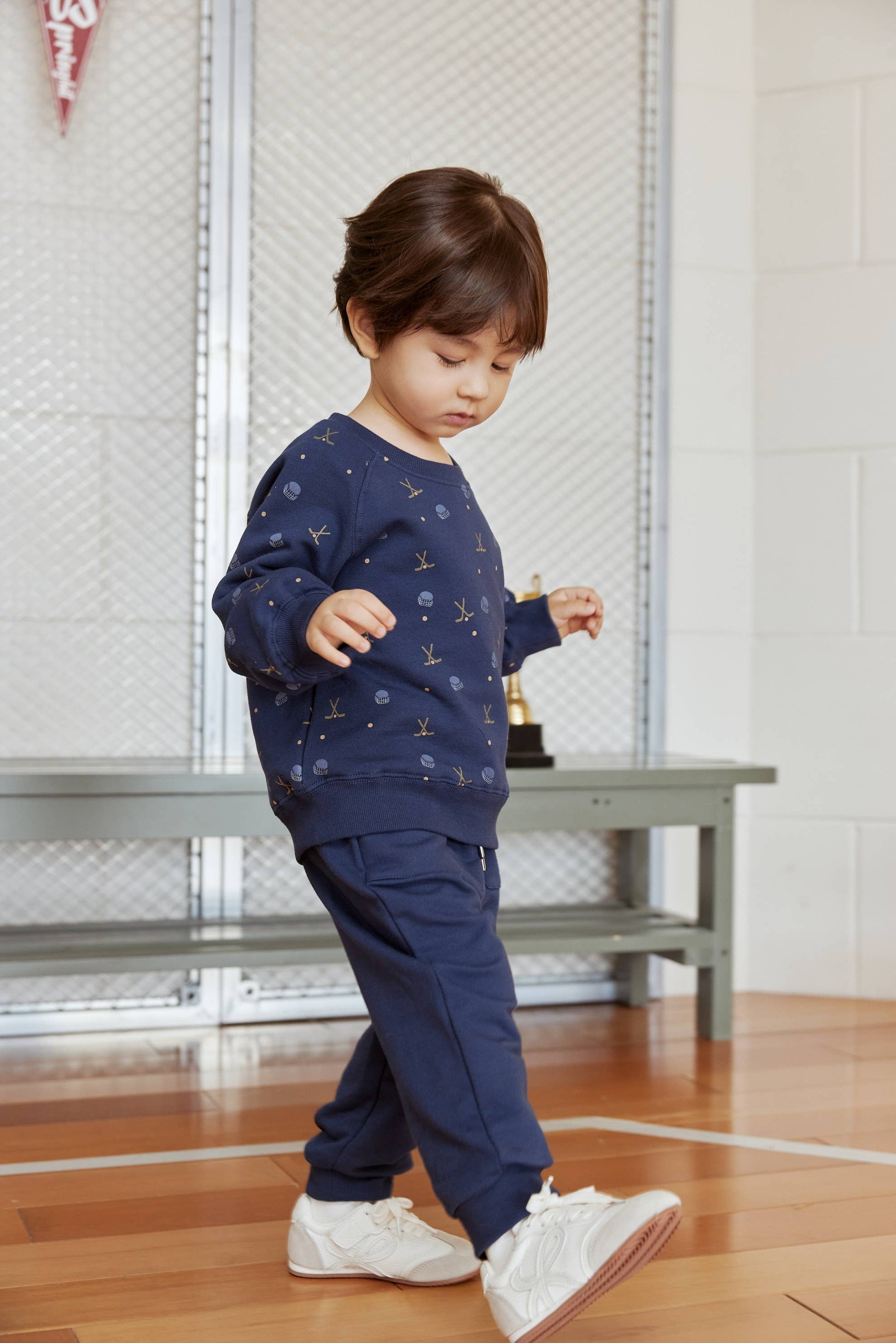 Child wearing a navy blue outfit with star patterns indoors.