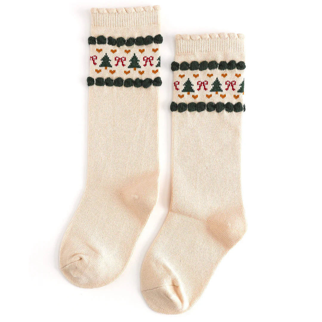 Pair of cream socks with festive pattern on a white background