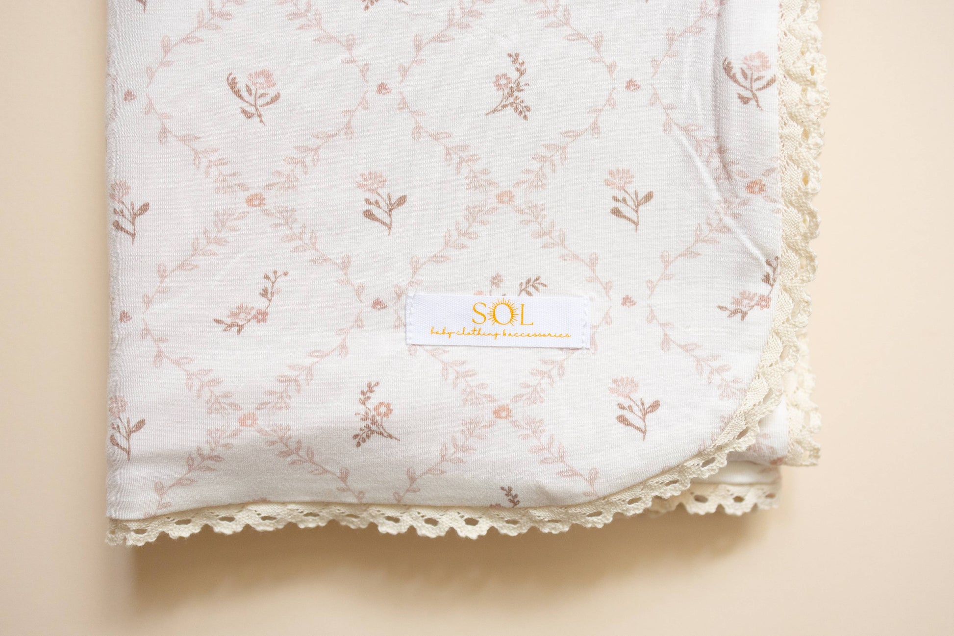 Floral-patterned fabric with a brand label on a beige background