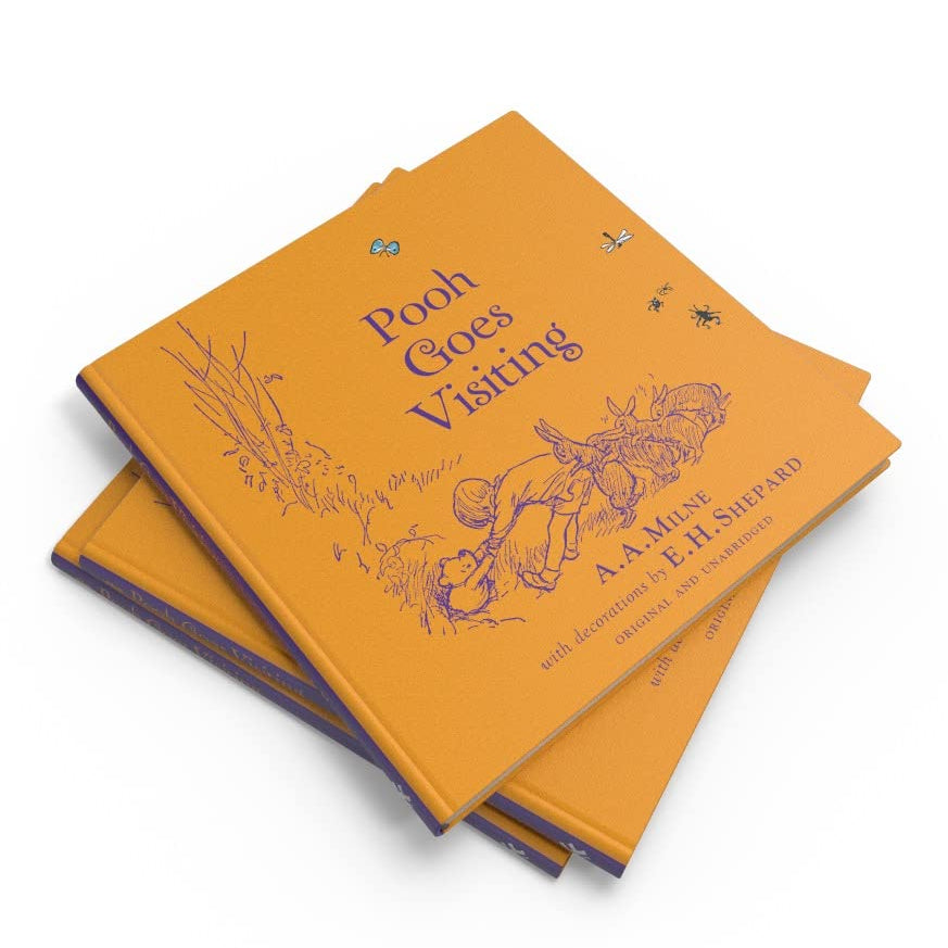 Two orange books titled 'Pooh Goes Visiting' by A.A. Milne on a white background