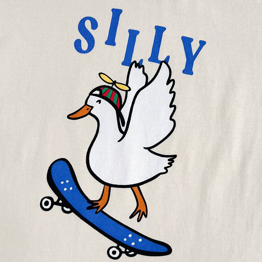 Beige sweatshirt with a cartoon duck on a skateboard and the word 'SILLY' above it.