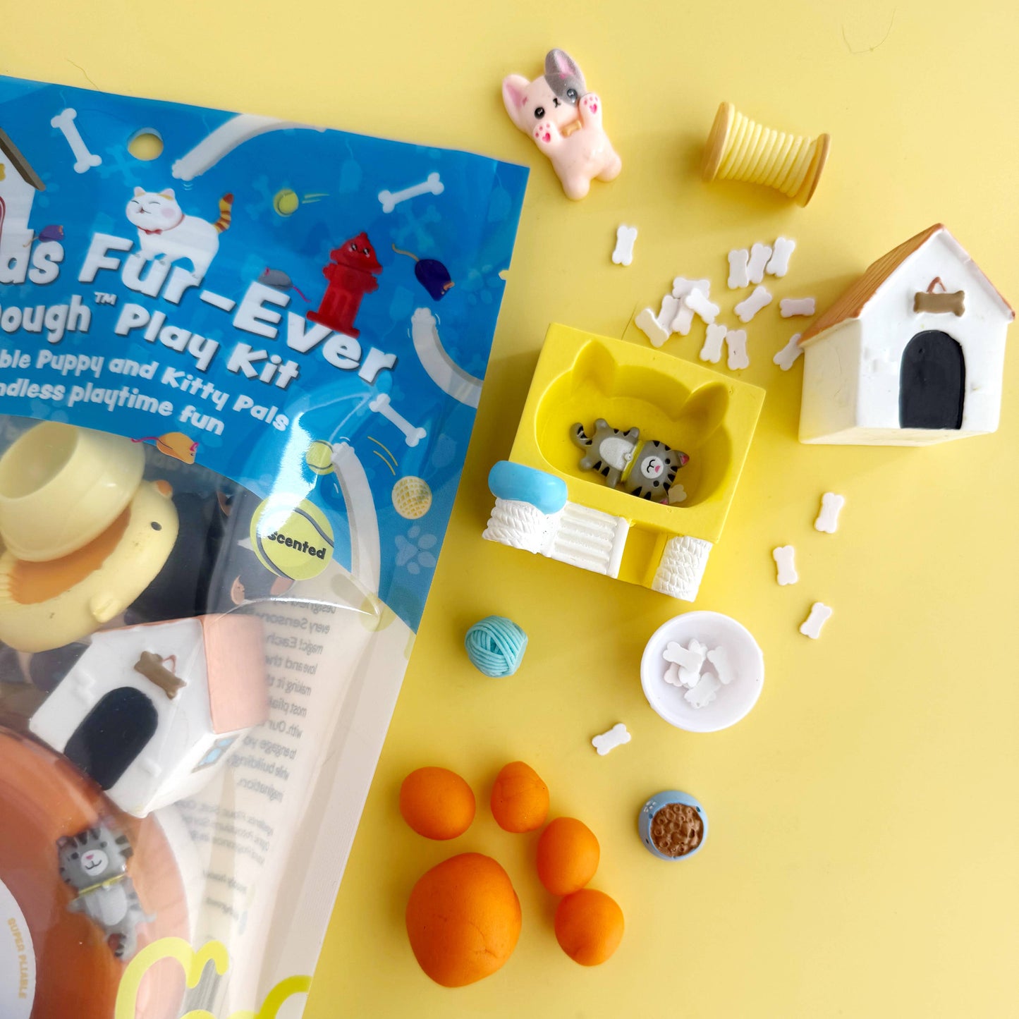 Dog toy play kit with packaging on a yellow background