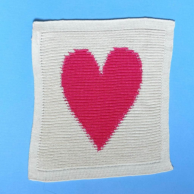 Textile product with a pink heart design on a blue background