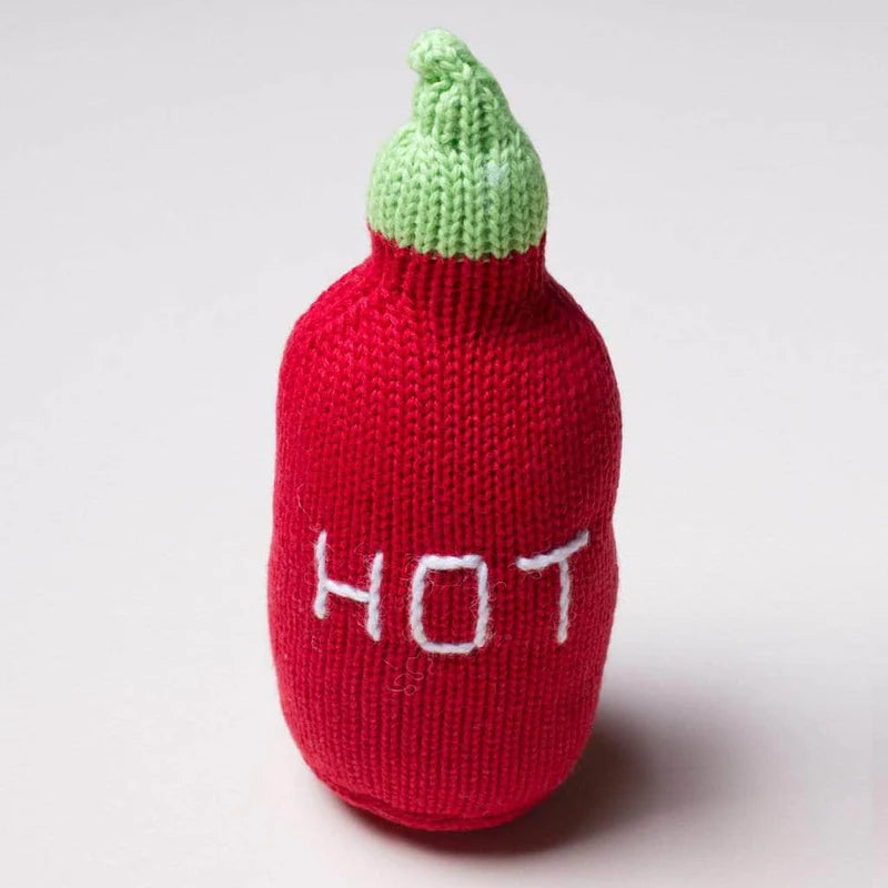 Knitted red chili pepper toy with green top and 'HOT' text on a white background