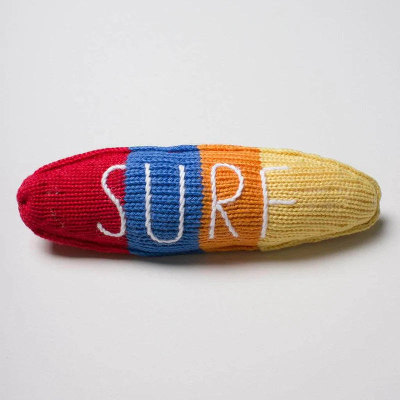 Colorful knit dog toy with 'SURF' text on a light gray background